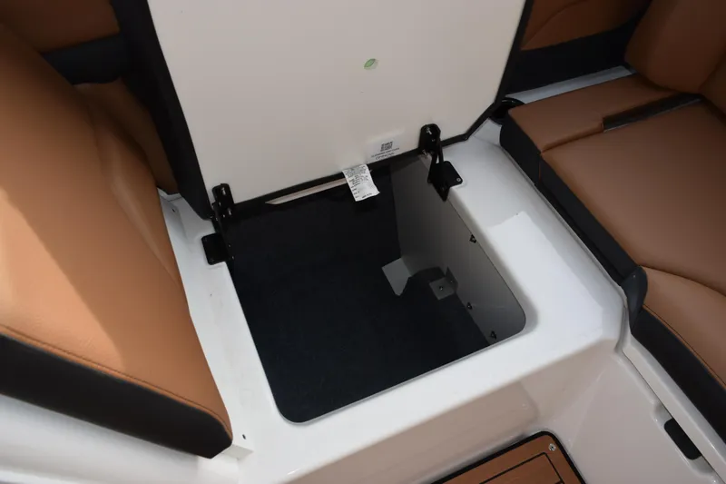 Slide: The Image of 2026 Yamaha Boats 252SD storage compartment with brown seating and open hatch. - 16