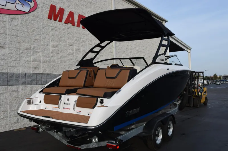 Slide: The Image of 2026 Yamaha Boats 252SD on trailer, displayed outside marine dealership. - 4