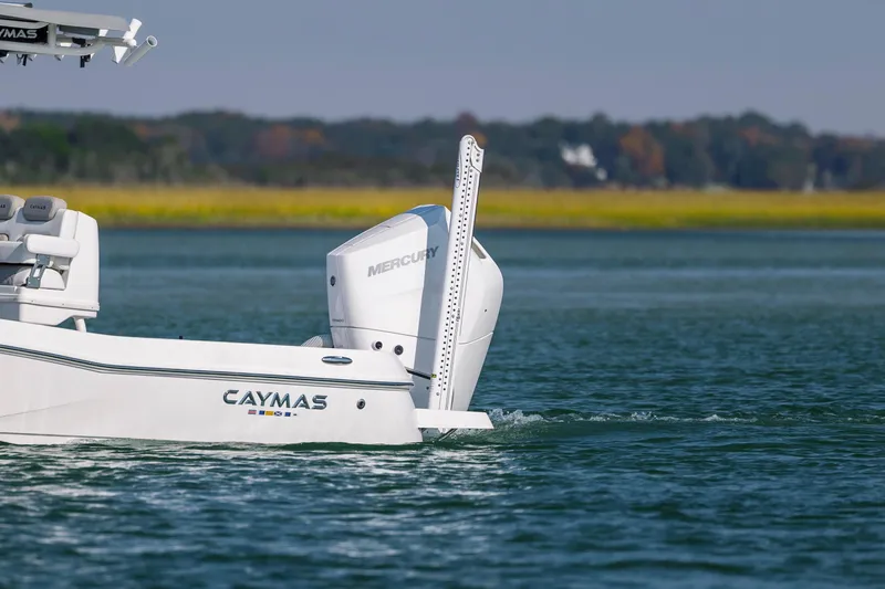 Slide: The Image of 2024 Caymas 26 HB boat with Mercury engine on calm water. - 11