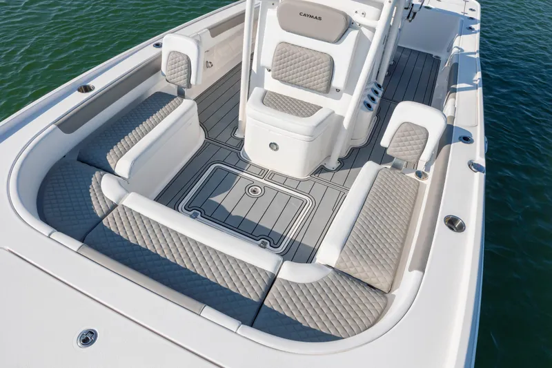 Slide: The Image of 2024 Caymas 26 HB boat interior with cushioned seating and sleek design on water. - 14