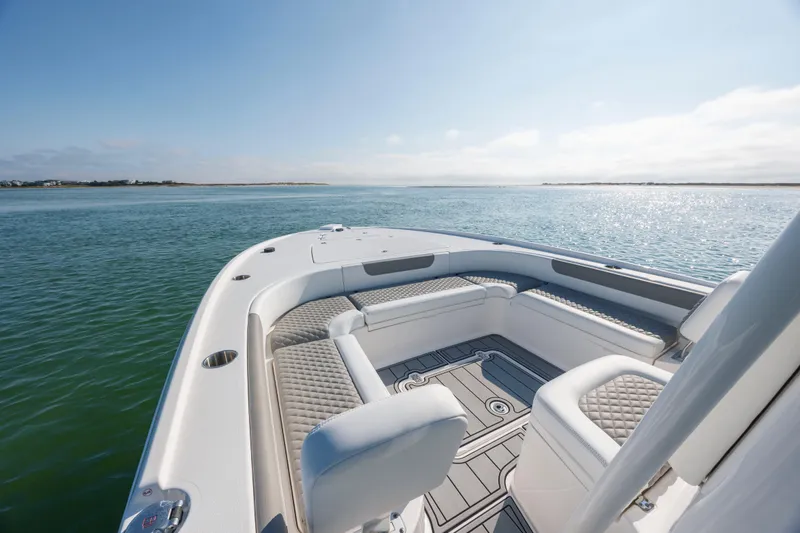 Slide: The Image of 2024 Caymas 26 HB boat interior with luxurious seating on calm water. - 15