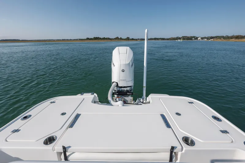 Slide: The Image of 2024 Caymas 26 HB boat with outboard motor on calm water. - 24