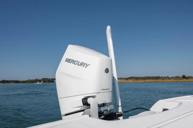 Slide: The Image of 2024 Caymas 26 HB boat with Mercury Verado engine on calm water. - 27