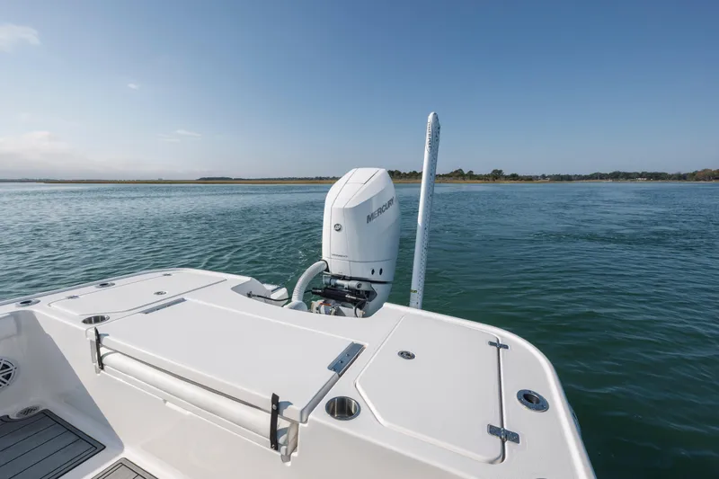 Slide: The Image of 2024 Caymas 26 HB boat with Mercury engine on calm water. - 28