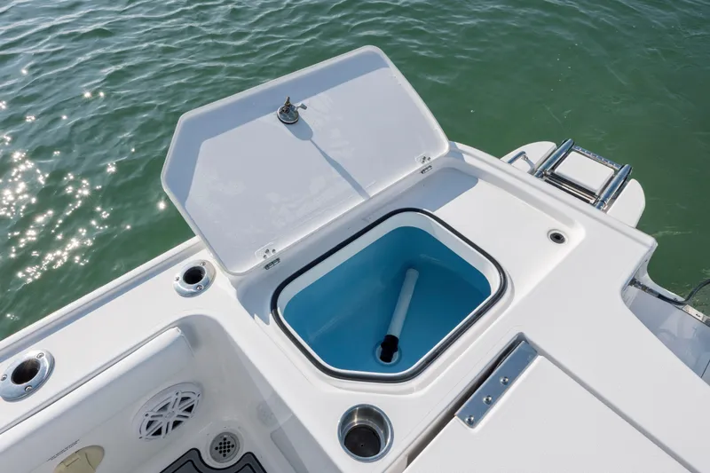 Slide: The Image of 2024 Caymas 26 HB boat with open storage compartment on deck. - 33