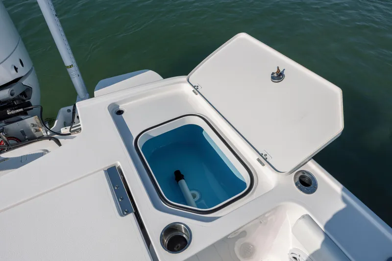 Slide: The Image of 2024 Caymas 26 HB boat with open storage compartment on deck. - 34