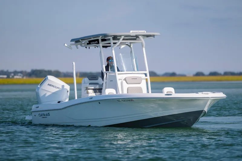 Slide: The Image of 2024 Caymas 26 HB boat on water, featuring Mercury engine and sleek design. - 5