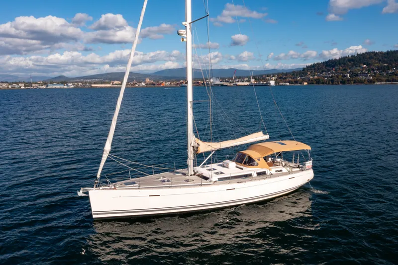 Slide: The Image of Sailing yacht Dufour 525 Grand Large 2011 on open water, clear sky background. - 11