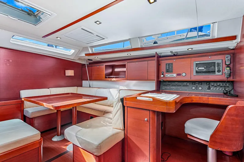 Slide: The Image of Luxurious interior of 2011 Dufour 525 Grand Large yacht with wood finish and navigation station. - 24