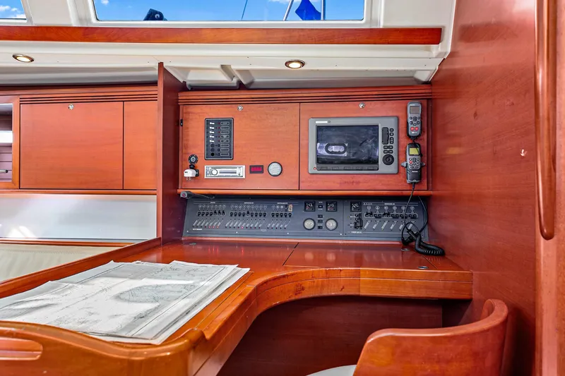 Slide: The Image of Navigation station on 2011 Dufour 525 Grand Large yacht with control panel and chart. - 35