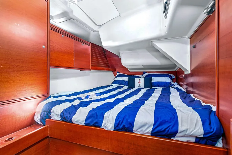 Slide: The Image of Cozy cabin interior of 2011 Dufour 525 Grand Large with striped bedding and wooden finish. - 42