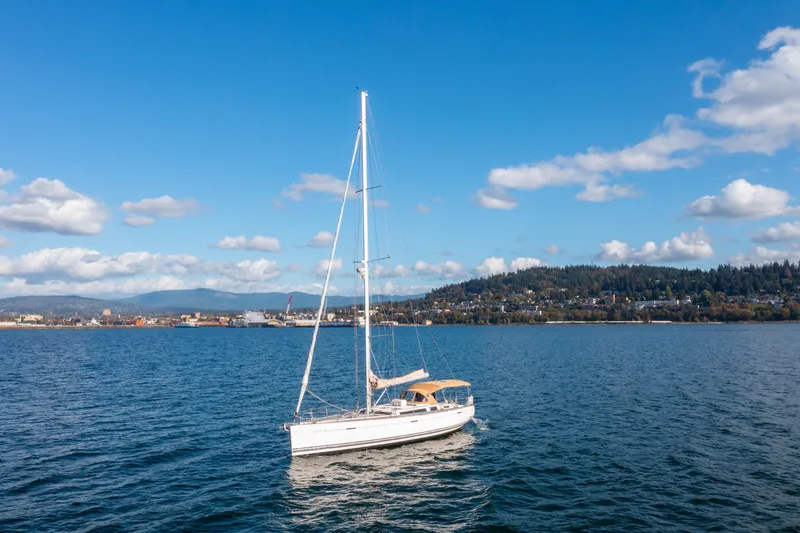 Slide: The Image of Sailboat Dufour 525 Grand Large 2011 on scenic lake with hills and clouds. - 9