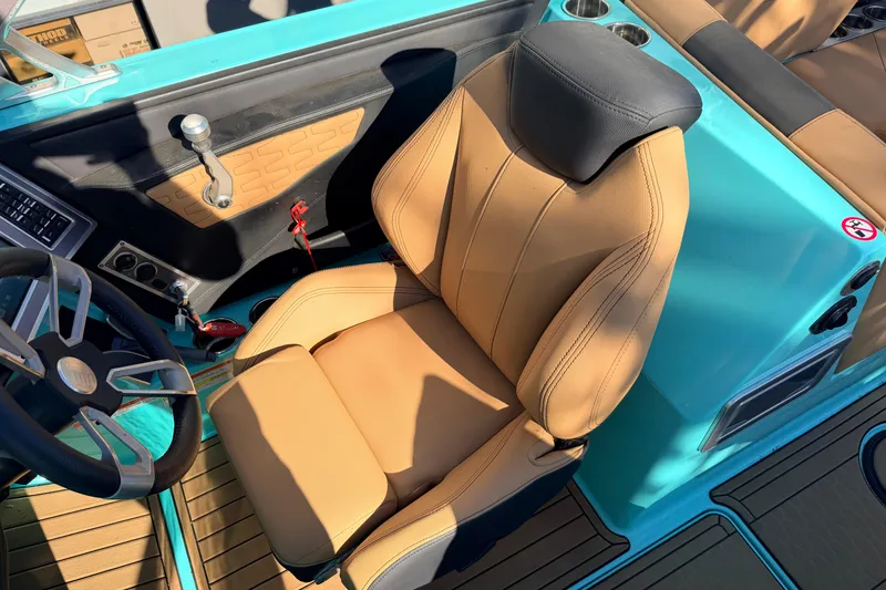 Slide: The Image of 2021 MasterCraft X26 boat interior with tan seat and turquoise accents. - 14