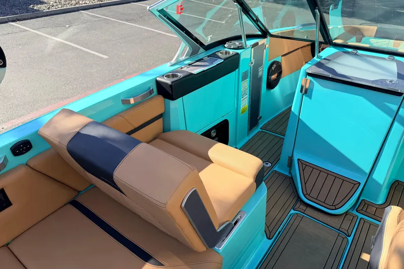 Slide: The Image of 2021 MasterCraft X26 boat interior with tan and turquoise seating, modern design. - 19