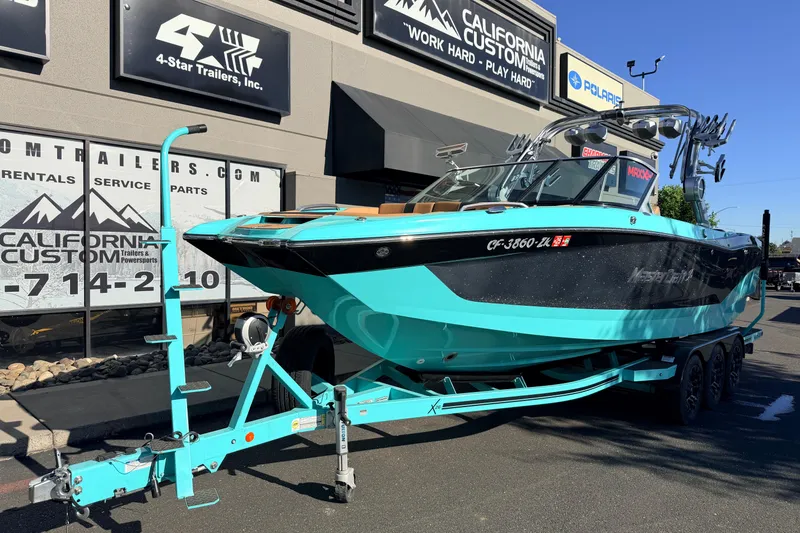 Slide: The Image of 2021 MasterCraft X26 boat on trailer at California Custom dealership. - 2