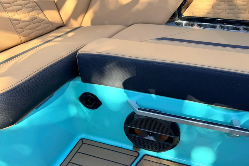 Slide: The Image of Interior of 2021 MasterCraft X26 boat with tan seating and blue accents. - 25