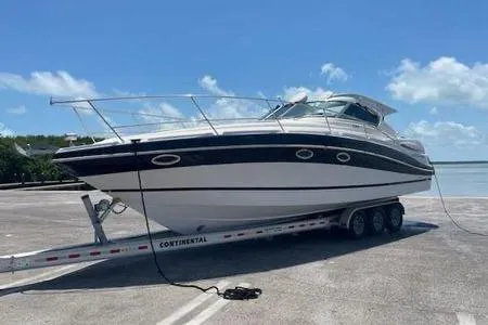 Slide: The Image of 2007 Four Winns V338 boat on trailer under clear blue sky. - 2