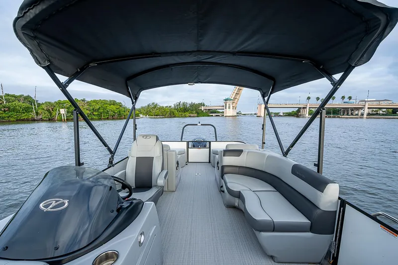 Slide: The Image of 2023 Veranda Relax VR22RFL pontoon boat with canopy on a scenic waterway. - 11