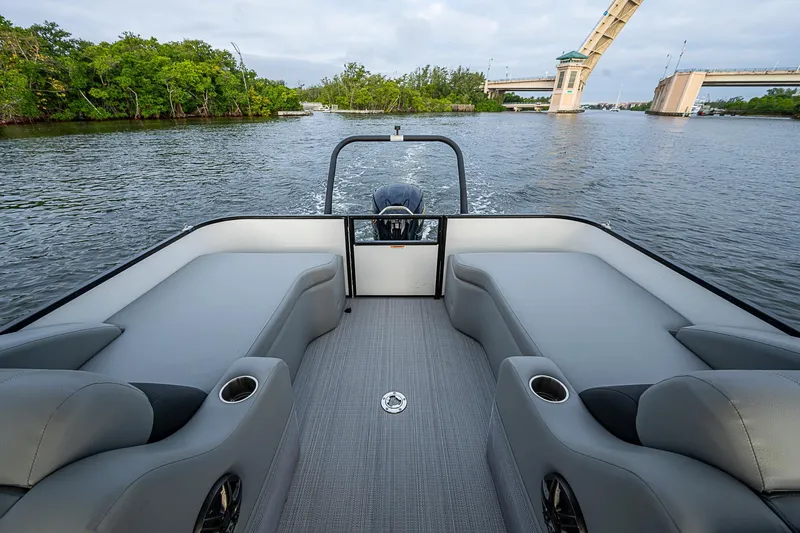 Slide: The Image of 2023 Veranda Relax VR22RFL pontoon boat interior with scenic waterway view. - 12