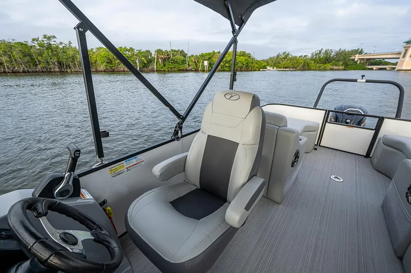 Slide: The Image of 2023 Veranda Relax VR22RFL pontoon boat interior with comfortable seating and scenic water view. - 13