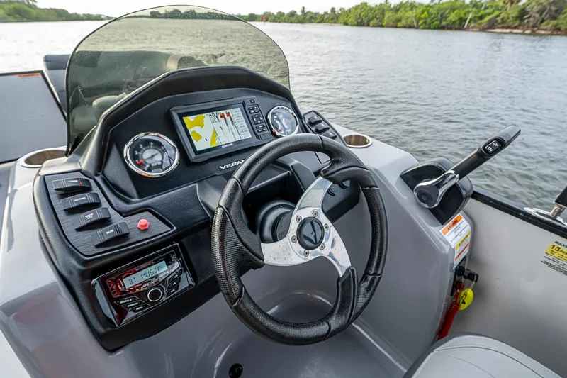 Slide: The Image of 2023 Veranda Relax VR22RFL boat dashboard with steering wheel and navigation system. - 14