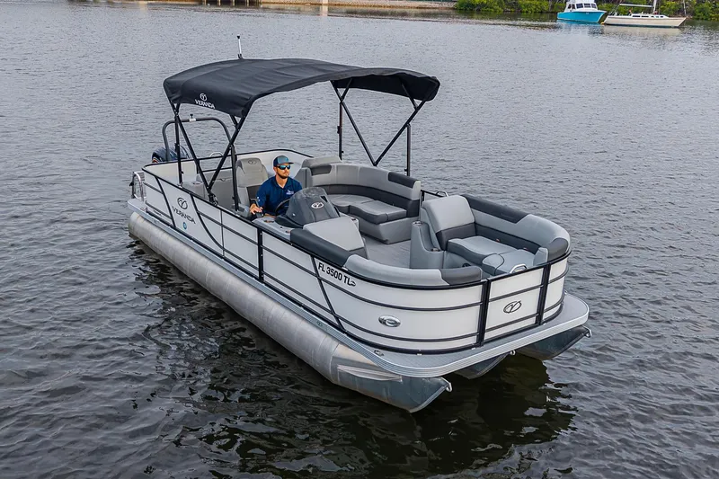 Slide: The Image of 2023 Veranda Relax VR22RFL pontoon boat on calm water, featuring spacious seating and canopy. - 16