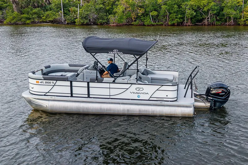 Slide: The Image of 2023 Veranda Relax VR22RFL pontoon boat on water, featuring Yamaha motor. - 18