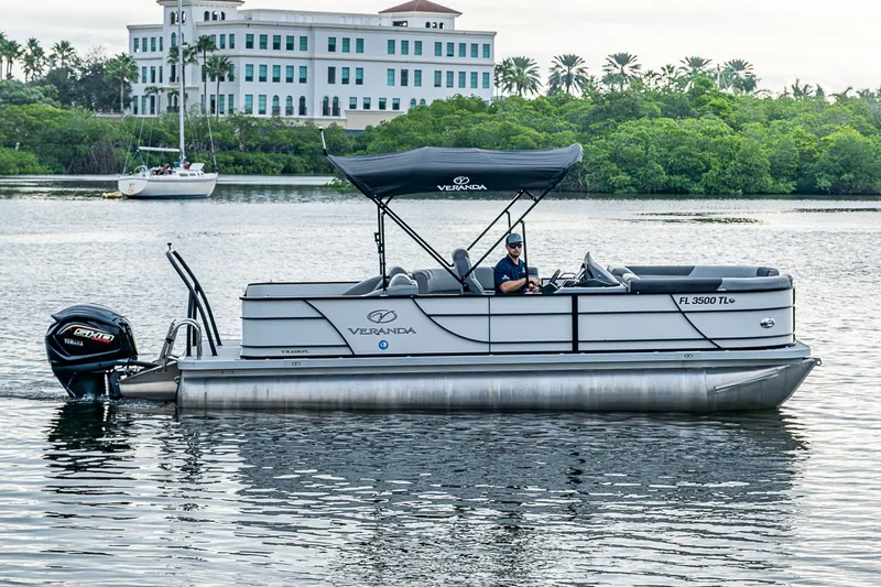 Slide: The Image of 2023 Veranda Relax VR22RFL pontoon boat on water, with canopy and Yamaha engine. - 3
