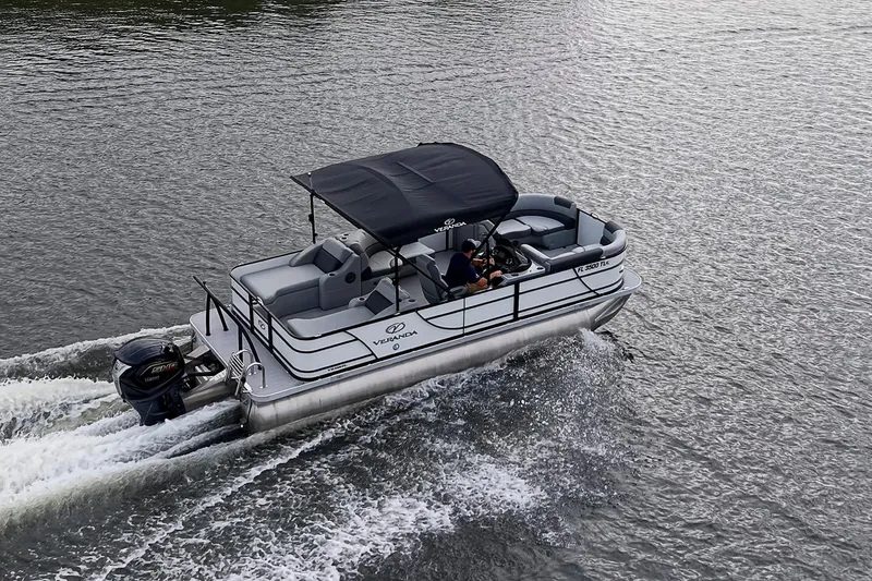 Slide: The Image of 2023 Veranda Relax VR22RFL pontoon boat cruising on a lake with canopy and outboard motor. - 6