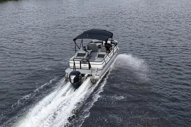 Slide: The Image of 2023 Veranda Relax VR22RFL pontoon boat cruising on open water. - 7