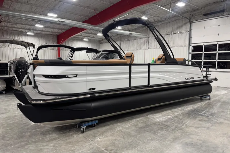 The Image of 2026 Sylvan L-5 pontoon boat in showroom, featuring sleek design and modern amenities. - 1