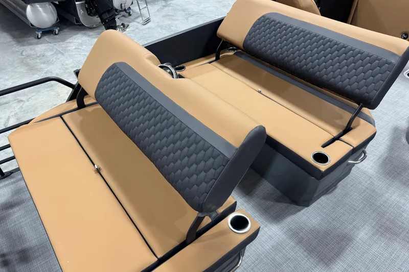 Slide: The Image of 2026 Sylvan L-5 boat seats with tan and gray upholstery, featuring cup holders. - 14