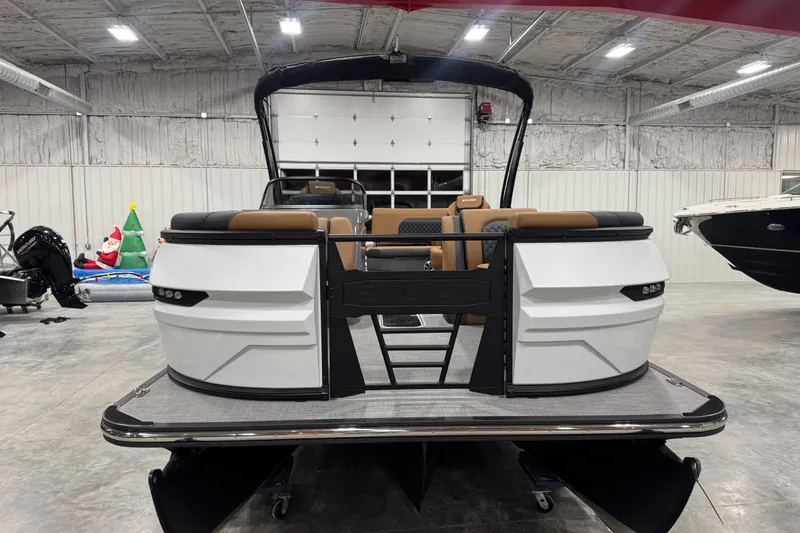 Slide: The Image of 2026 Sylvan L-5 pontoon boat in showroom, featuring modern design and spacious seating. - 3