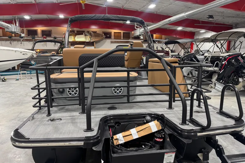 Slide: The Image of 2026 Sylvan L-5 pontoon boat in showroom, featuring sleek design and modern seating. - 6