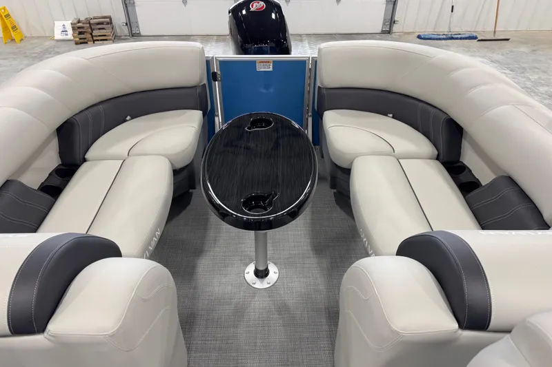 Slide: The Image of 2025 Sylvan 8522 Mirage pontoon boat interior with plush seating and sleek table design. - 11