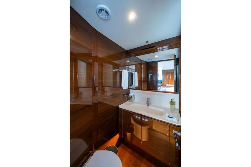 Slide: The Image of Luxurious bathroom in 2022 Princess X95 yacht with modern fixtures and wooden accents. - 22