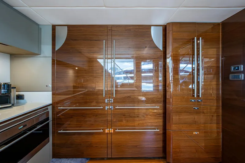 Slide: The Image of Luxurious kitchen interior on 2022 Princess X95 yacht with sleek wooden cabinetry. - 26
