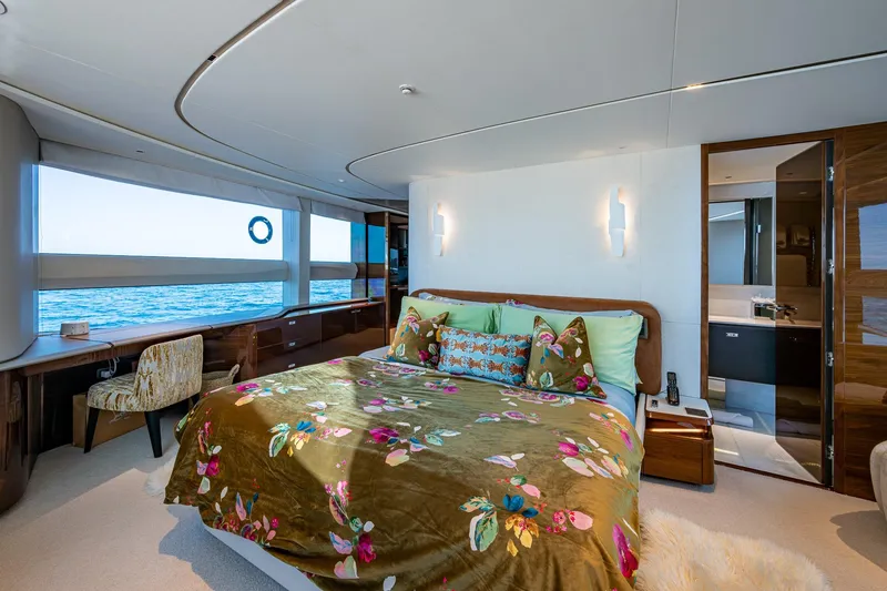 Slide: The Image of Luxurious 2022 Princess X95 yacht bedroom with ocean view, elegant decor, and floral bedding. - 29