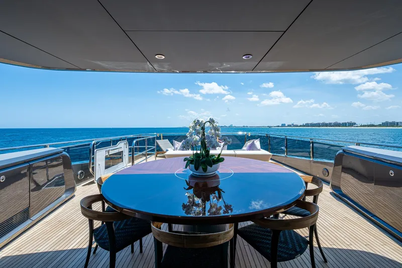 Slide: The Image of Luxurious 2022 Princess X95 yacht deck with ocean view and elegant dining setup. - 72