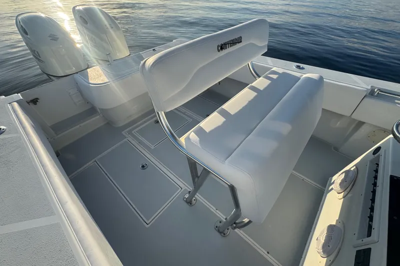 Slide: The Image of 1998 Contender 25 Open boat interior with dual engines and white seating. - 10