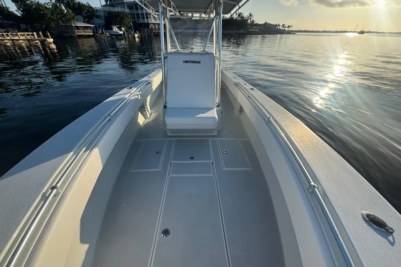 Slide: The Image of 1998 Contender 25 Open boat on calm water at sunset, showcasing spacious deck. - 18
