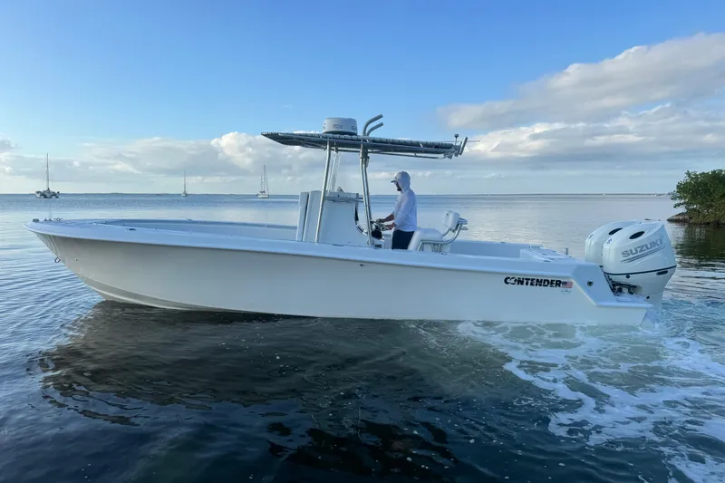 Slide: The Image of 1998 Contender 25 Open boat cruising on calm waters under a clear blue sky. - 5