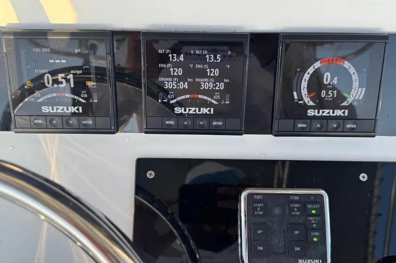 Slide: The Image of 1998 Contender 25 Open boat dashboard with Suzuki engine displays and controls. - 7