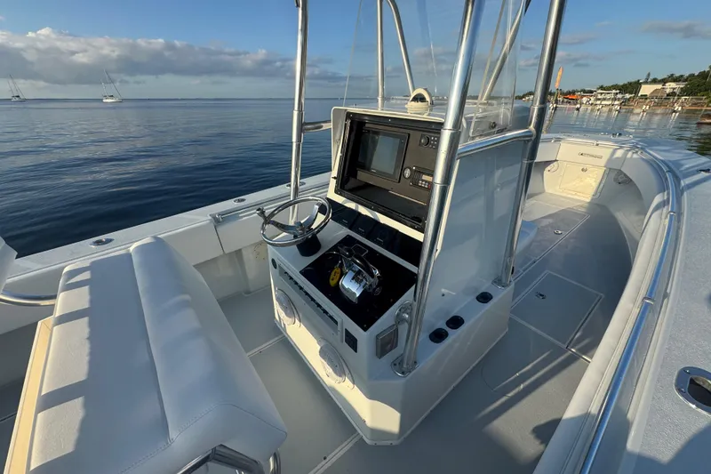 Slide: The Image of 1998 Contender 25 Open boat interior with steering console, calm water, and clear sky. - 9