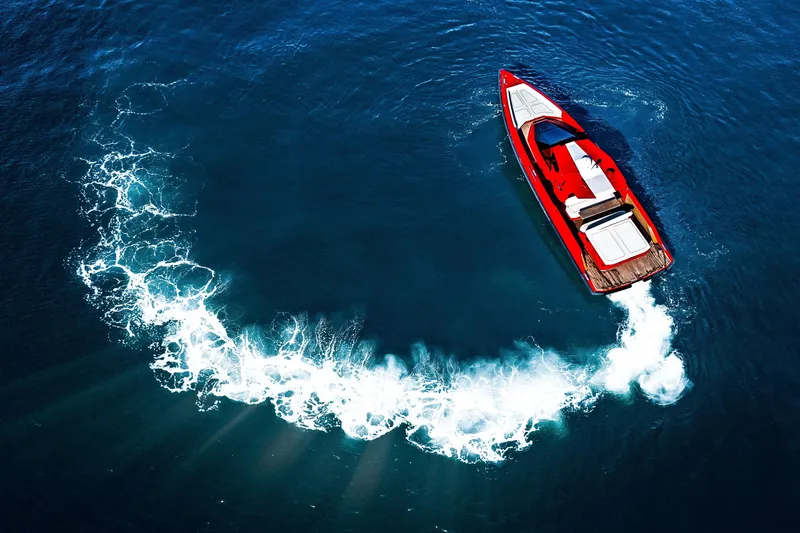 Slide: The Image of Red 2021 Wally 48ft yacht making a circular wake in deep blue ocean. - 3