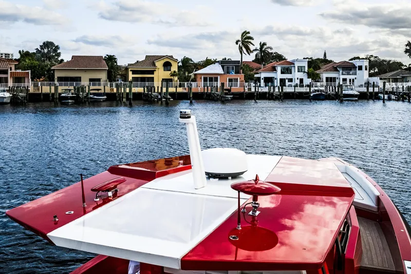 Slide: The Image of Red Wally 48ft yacht on water, 2021 model, with waterfront homes in background. - 6