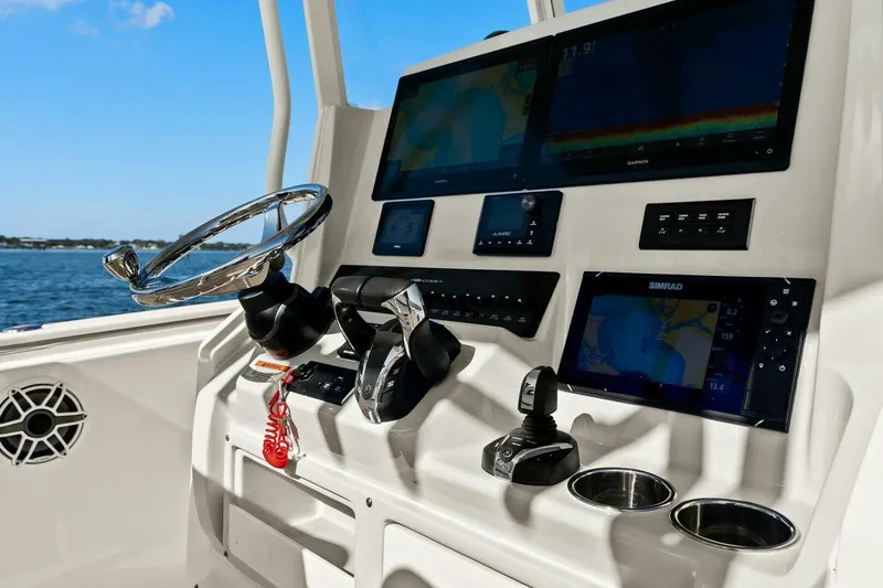 Slide: The Image of 2023 Cobia 301 Center Console dashboard with advanced navigation and control systems. - 18