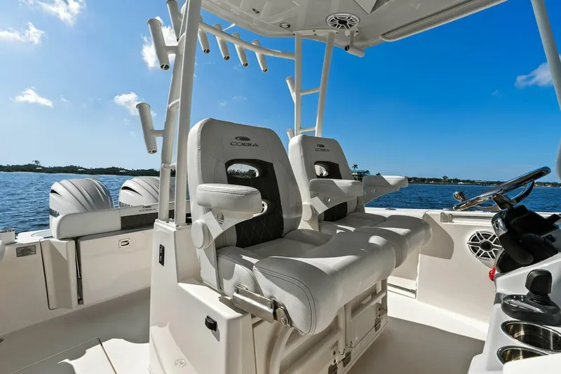 Slide: The Image of 2023 Cobia 301 Center Console boat interior with dual seats and ocean view. - 26