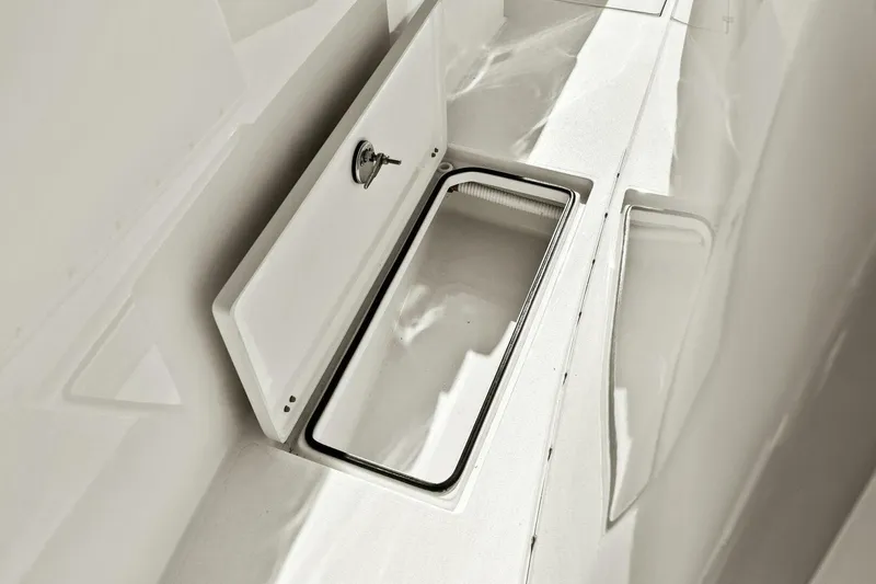 Slide: The Image of 2023 Cobia 301 Center Console storage compartment detail. - 29