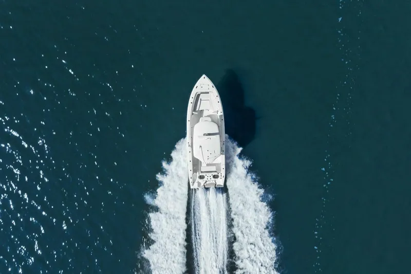 Slide: The Image of Aerial view of 2023 Cobia 301 Center Console boat cruising on open water. - 30